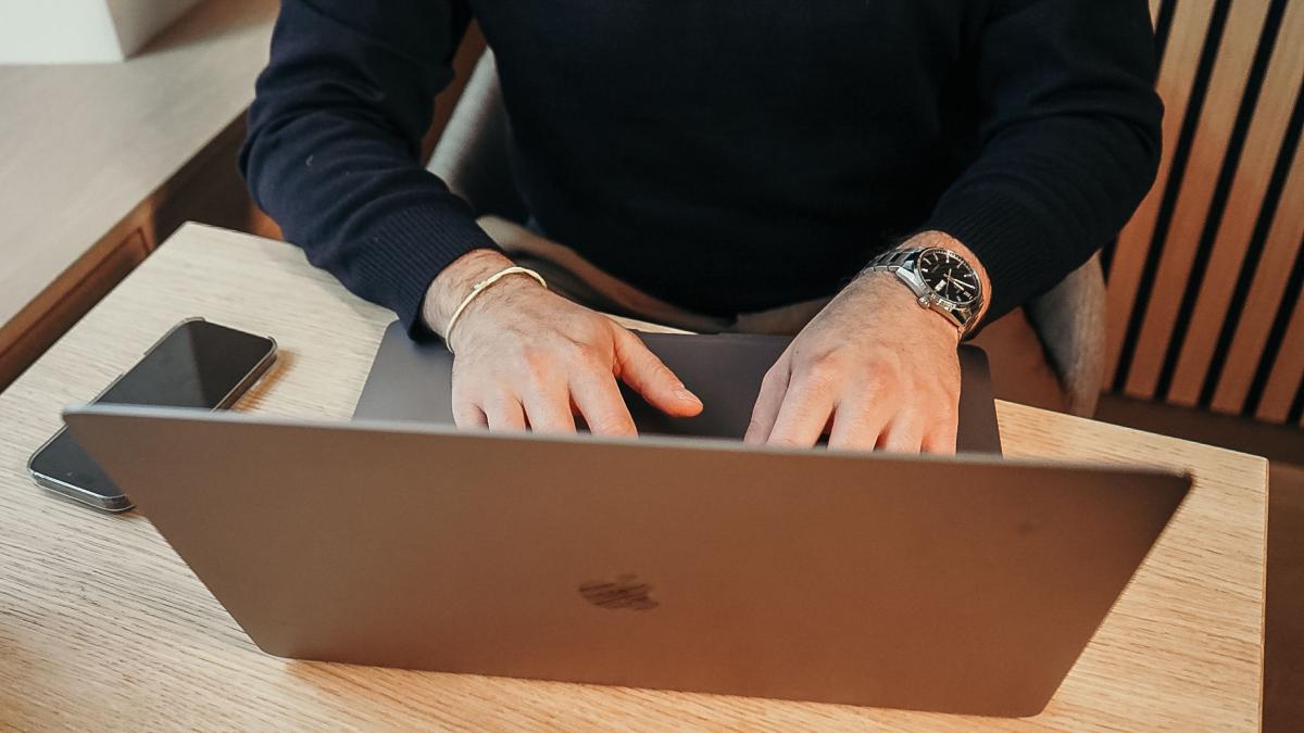 Eine starke souveräne Persönlichkeit arbeitet konzentriert am Laptop.